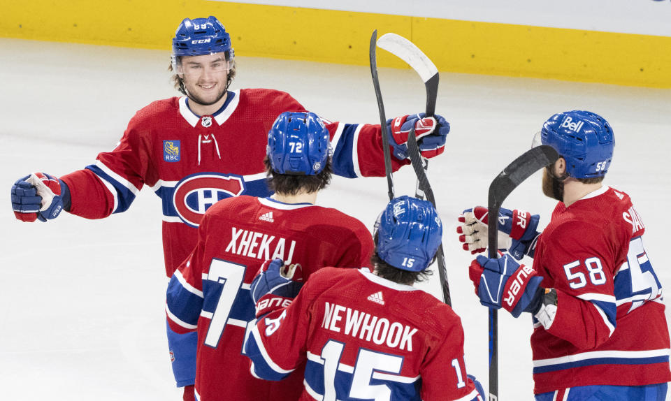 Montreal Canadiens' Joshua Roy (89) celebrates his goal against the Columbus Blue Jackets with Arber Xhekaj (72), Alex Newhook (15) and David Savard (58) during the first period of an NHL hockey game Tuesday, March 12, 2024, in Montreal. (Christinne Muschi/The Canadian Press via AP)