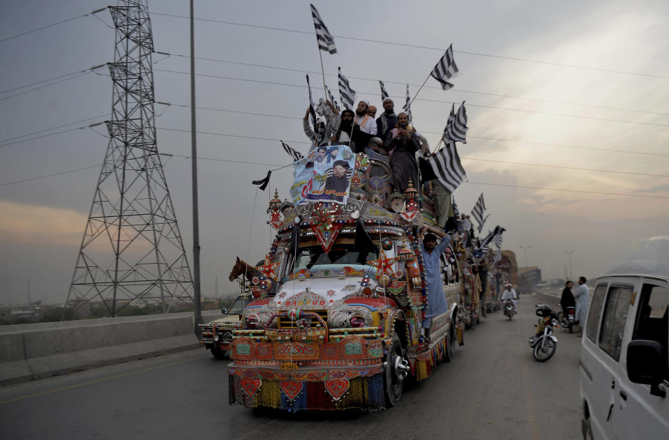 Supporters of the Pakistani firebrand cleric Maulana Fazlur Rehman, head of the Jamiat Ulema-e-Islam party, leave for Islamabad to participate in an anti government march, in Peshawar, Pakistan, Thursday, Oct. 31, 2019. Thousands of supporters of the ultra-religious political party led by Rehman took part in the anti-government procession headed to Pakistan's capital. (AP Photo/Muhammad Sajjad)