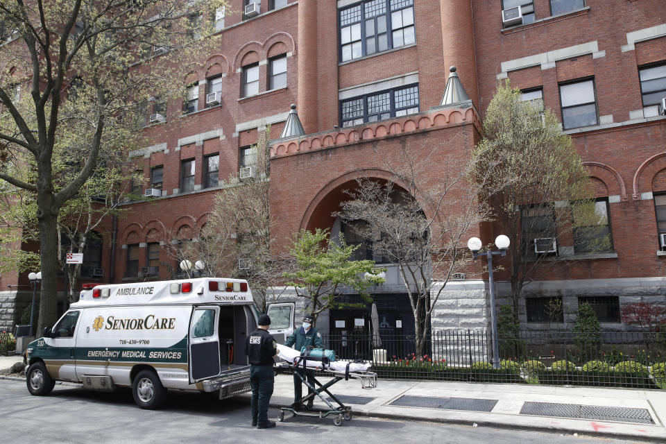 FILE - In this April 17, 2020, file photo, emergency medical workers arrive at Cobble Hill Health Center in the Brooklyn borough of New York. New York state is now reporting more than 1,700 previously undisclosed deaths at nursing homes and adult care facilities as the state faces scrutiny over how it’s protected vulnerable residents during the coronavirus pandemic. (AP Photo/John Minchillo, File)