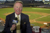 FILE - In this July 3, 2002, file photo, Los Angeles Dodgers television play-by-play announcer Vin Scully rehearses before a baseball game between the Dodgers and the Arizona Diamondbacks in Phoenix. To baseball fans, opening day is an annual rite of spring that evokes great anticipation and warm memories. This year's season was scheduled to begin Thursday, March 26, 2020, but there will be no games for a while because of the coronavirus outbreak. (AP Photo/Paul Connors, File)