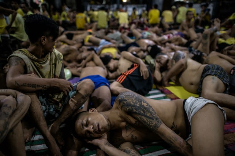 Inmates sleep shoulder to shoulder on the ground inside the overcrowded Quezon City Jail, in the Philippines