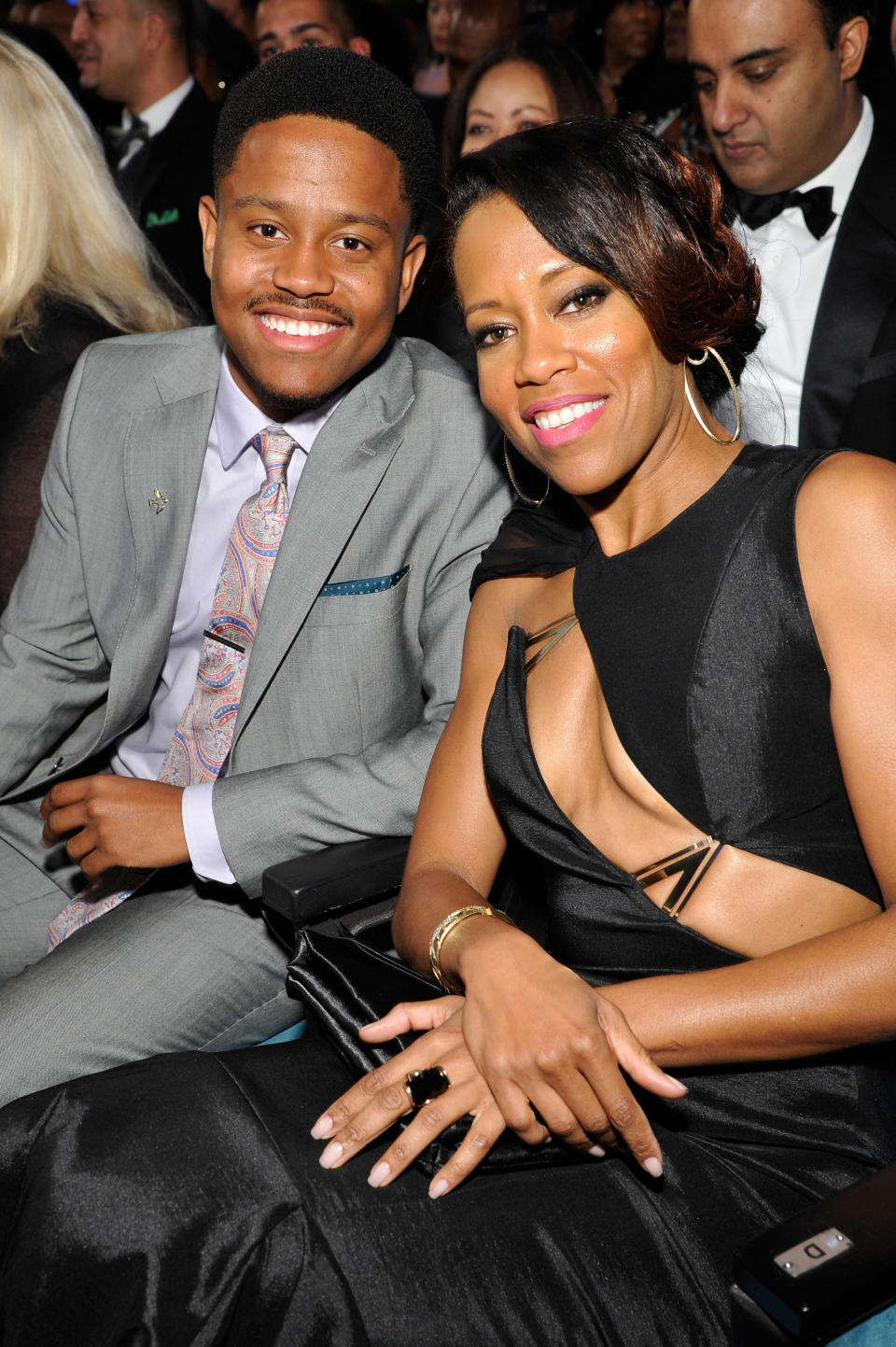 A closeup of the mother and son sitting in the audience for an event