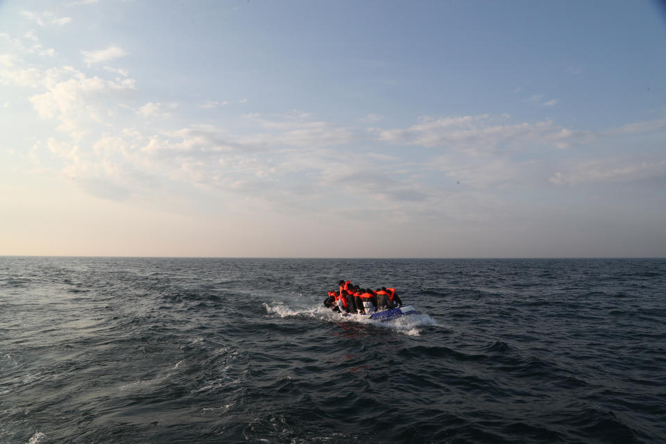 A group of people thought to be migrants crossing The Channel in a small boat headed in the direction of Dover, Kent. (Photo by Gareth Fuller/PA Images via Getty Images)