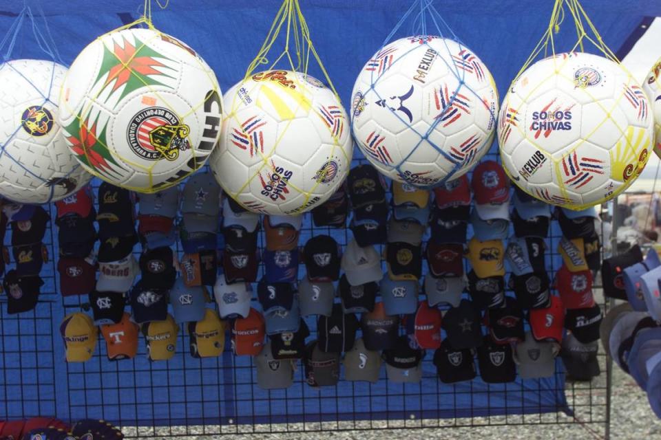 Herald/Richard Dickin Soccer balls and ball caps, many with Mexican team logos, are hot selling items at the market.