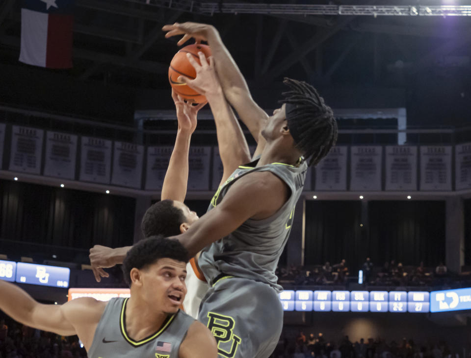 Baylor guard Ja'Kobe Walter, right, and guard Rayj Dennis, left, go up to block the shot of Texas forward Dylan Disu, center, during the second half of an NCAA college basketball game, Saturday, Jan. 20, 2024, in Austin, Texas. Texas won 75-73. (AP Photo/Michael Thomas)