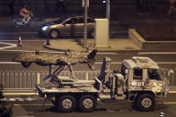 In this Saturday, Sept. 21, 2019, photo, a Chinese military vehicle carrying what appears to be a drone passes along the Jianguomenwai Avenue during a rehearsal for the 70th anniversary of Communist China, in Beijing. A parade on Tuesday, Oct. 1 by China’s secretive military will offer a rare look at its rapidly developing arsenal, including possibly a nuclear-armed missile that could reach the United States in 30 minutes, as Beijing gets closer to matching Washington and other powers in weapons technology. (AP Photo/Mark Schiefelbein)