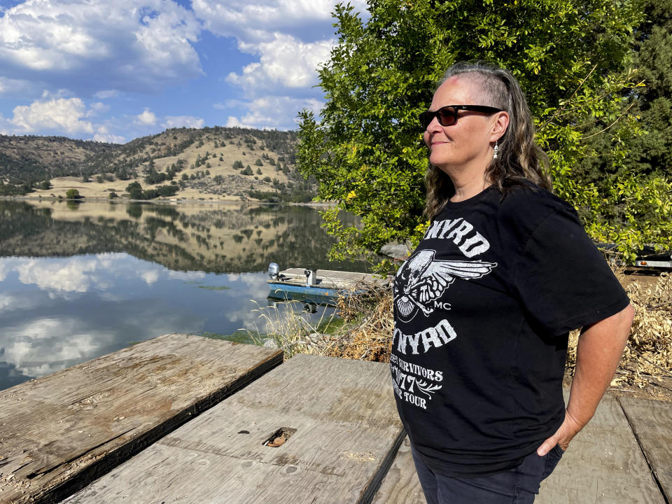 Sami Jo Difuntorum, Cultural Preservation Officer, Shasta Indian Nation, looks out on Sunday, Sept. 17, 2023, at a reservoir from Copco 1 damn, that will be drawn down next year as part of the largest dam removal project in United States history. The Shasta Indian Nation hopes to reclaim some of its land which was flooded when the dams were built a century ago. (AP Photo/Haven Daley)