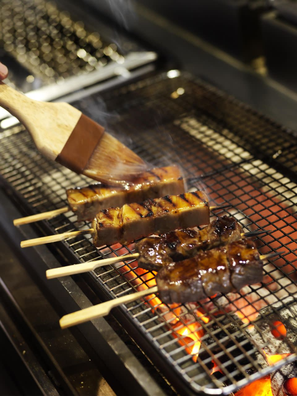 Beef and chicken skewers cooking on the grill set which is Yamagen's centrepiece cooking station.