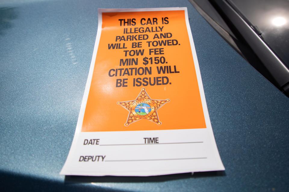 A sticker that reads "This car is illegally parked and will be towed. Tow fee min $150. Citation will be issued" are placed on the windshields of vehicles illegally parked in Franklin County.