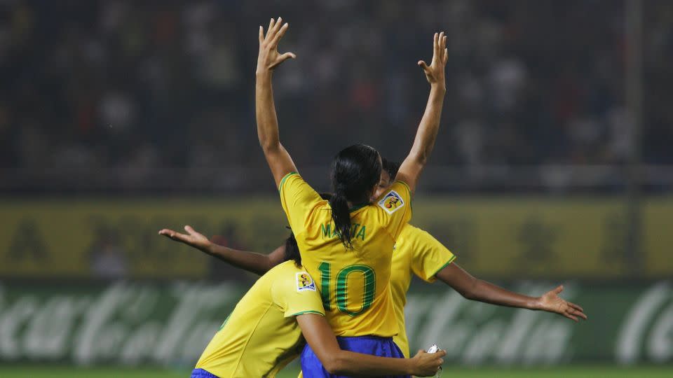 Marta celebrates with her teammates after her stunning solo goal against the USA. - Feng Li/Getty Images