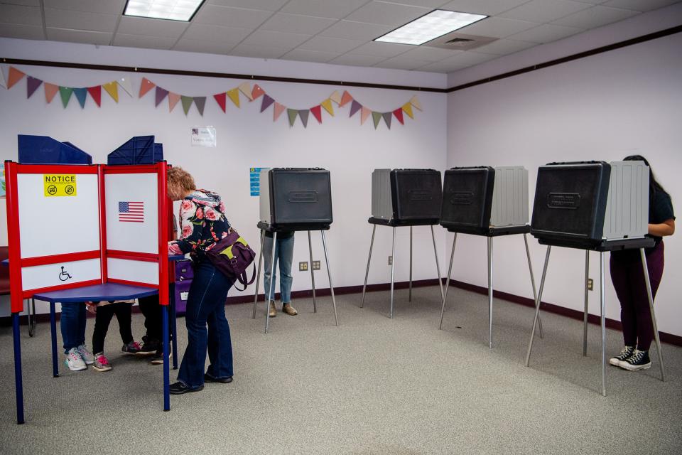 Voters fill in their ballots at the West Asheville Library, March 5, 2024.