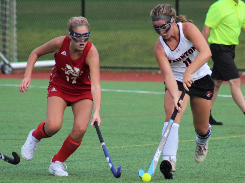 Taunton's Kaysie DeMoura moves the ball past North Attleboro's Francesca Spencer during a game on September 12, 2022.