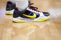 New Orleans Pelicans guard Josh Hart bears a memorial message on his shoes for former NBA great Kobe Bryant, who died today in a helicopter crash, in the first half of an NBA basketball game against the Boston Celtics in New Orleans, Sunday, Jan. 26, 2020. (AP Photo/Gerald Herbert)