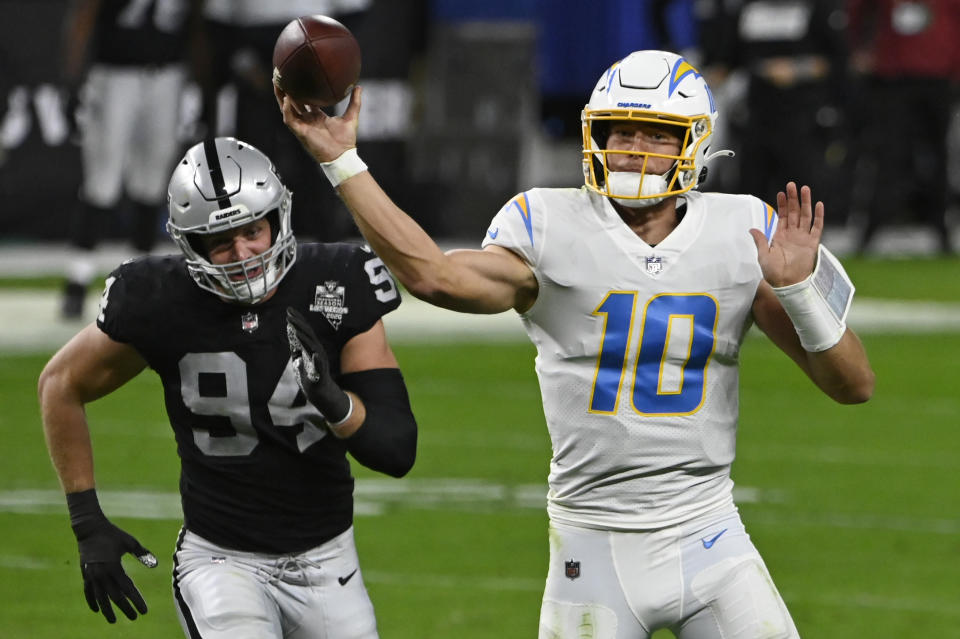 Los Angeles Chargers quarterback Justin Herbert (10) throws against the Las Vegas Raiders during the first half of an NFL football game, Thursday, Dec. 17, 2020, in Las Vegas. (AP Photo/David Becker)