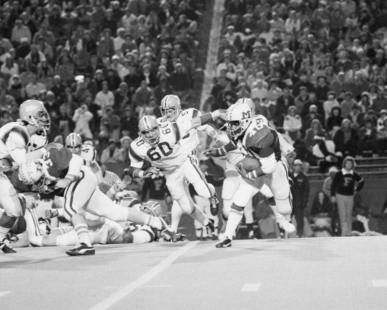 Miami of Ohio tailback Bob Hitchens (40) evades University of Florida defender John Lancer (60) to gain a first-quarter first down in the Tangerine Bowl, Dec. 22, 1973, Gainesville, Fla.