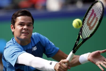 Milos Raonic of Canada returns a shot to Thomaz Bellucci of Brazil during their men's singles match at the Shanghai Masters tennis tournament in Shanghai, China, October 13, 2015. REUTERS/Aly Song
