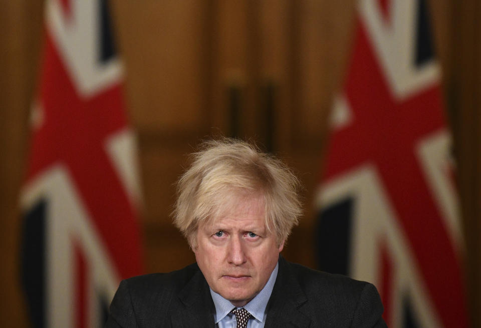 Britain's Prime Minister Boris Johnson leads a virtual press conference on the Covid-19 pandemic, from inside 10 Downing Street in central London Tuesday Jan. 26, 2021. Official data shows that more than 100,000 people have died after testing positive for coronavirus in Britain, since the pandemic took hold last year. (Photo by JUSTIN TALLIS / POOL / AFP)