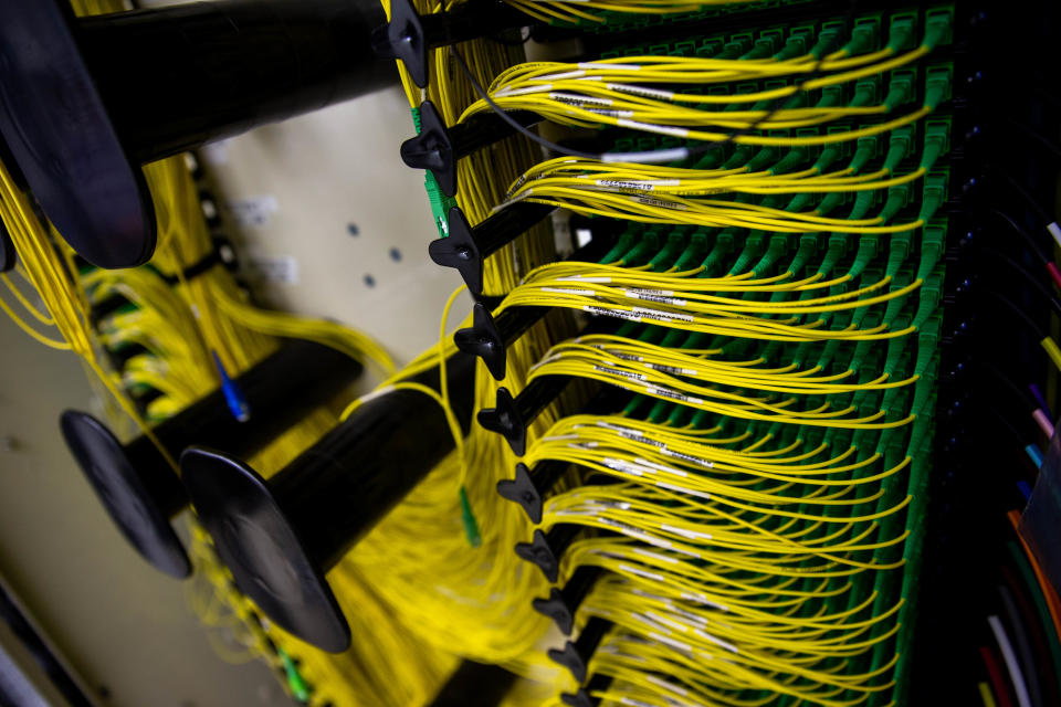 Hundreds of fiber optic cables connect to a server in an enclosed climate-controlled hut Thursday, May 5, 2022, in downtown Holland.