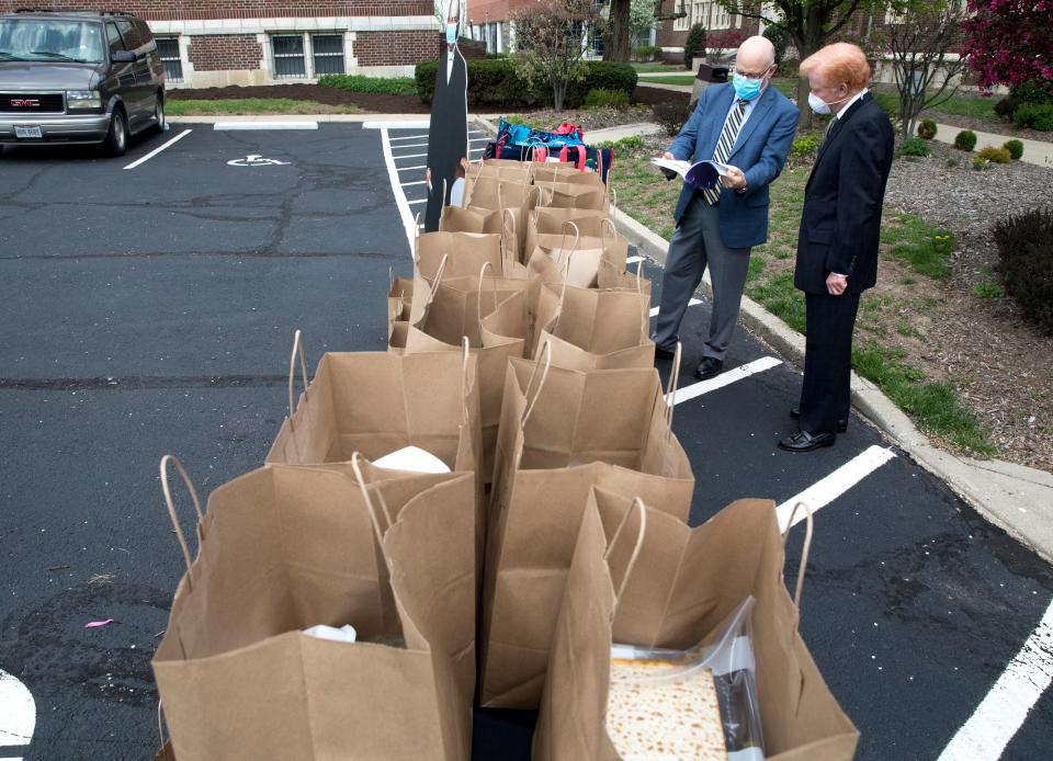 Rabbi Jonathan Hecht, Hebrew Union College dean, speaks with Rabbi Gary Zola Hebrew Union College professor, as they prepare to hand out Seder meals to students to take home for a virtual celebration of Seder on Wednesday, April 8, 2020, at Hebrew Union College in University Heights. Hecht and HUC Rabbi Gary Zola are hosting virtual Seders for students to attend with their prepared meals.