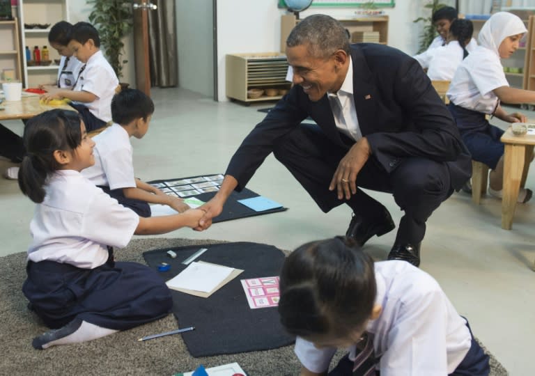 US President Barack Obama speaks with primary school students as he tours the Dignity for Children Foundation in Kuala Lumpur on November 21, 2015