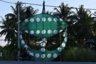 A motorcyclist passes a Parti Islam Se-Malaysia (Malaysian Islamic Party) wau or traditional kite in Kota Bharu, Kelantan, Malaysia April 12, 2018. Picture taken April 12, 2018. REUTERS/Stringer