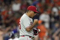 Philadelphia Phillies starting pitcher Ranger Suarez blows on his hand after giving up a home run to Houston Astros' Martin Maldonado during the second inning of a baseball game Tuesday, Oct. 4, 2022, in Houston. (AP Photo/David J. Phillip)