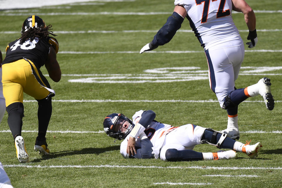 Denver Broncos quarterback Drew Lock (3) holds his arm after being injured while fumbling the ball during the first half of an NFL football game against the Pittsburgh Steelers, Sunday, Sept. 20, 2020, in Pittsburgh. (AP Photo/Keith Srakocic)