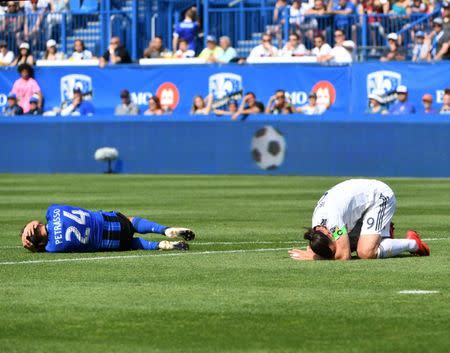 May 21, 2018; Montreal, Quebec, CAN; Montreal Impact defender Michael Petrasso (24) and Los Angeles Galaxy forward Zlatan Ibrahimovic (9) react on the turf during the first half at Stade Saputo. Mandatory Credit: Eric Bolte-USA TODAY Sports