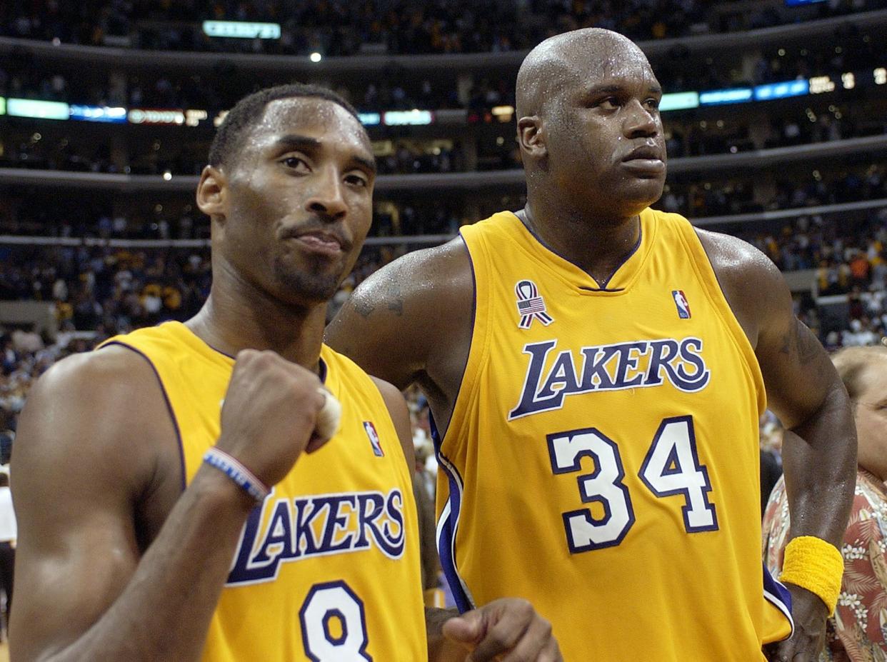 Los Angeles Lakers' Kobe Bryant, left, and Shaquille O'Neal celebrate after winning Game 5 of the Western Conference semifinals against the San Antonio Spurs, in Los Angeles on May 4, 2002.