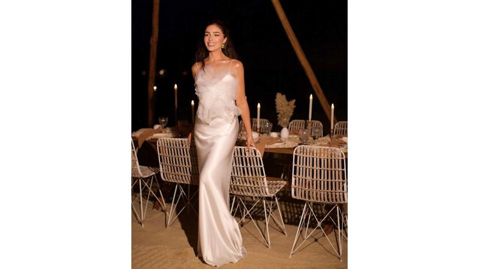 Olivia Culpo wearing a long satin dress for her bachelorette