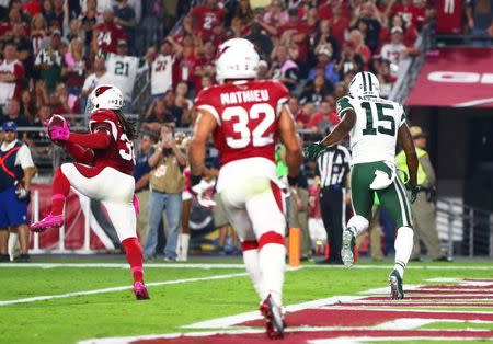 Oct 17, 2016; Glendale, AZ, USA; Arizona Cardinals safety D.J. Swearinger (left) intercepts a pass intended for New York Jets wide receiver Brandon Marshall (15) in the second half at University of Phoenix Stadium. Mandatory Credit: Mark J. Rebilas-USA TODAY Sports