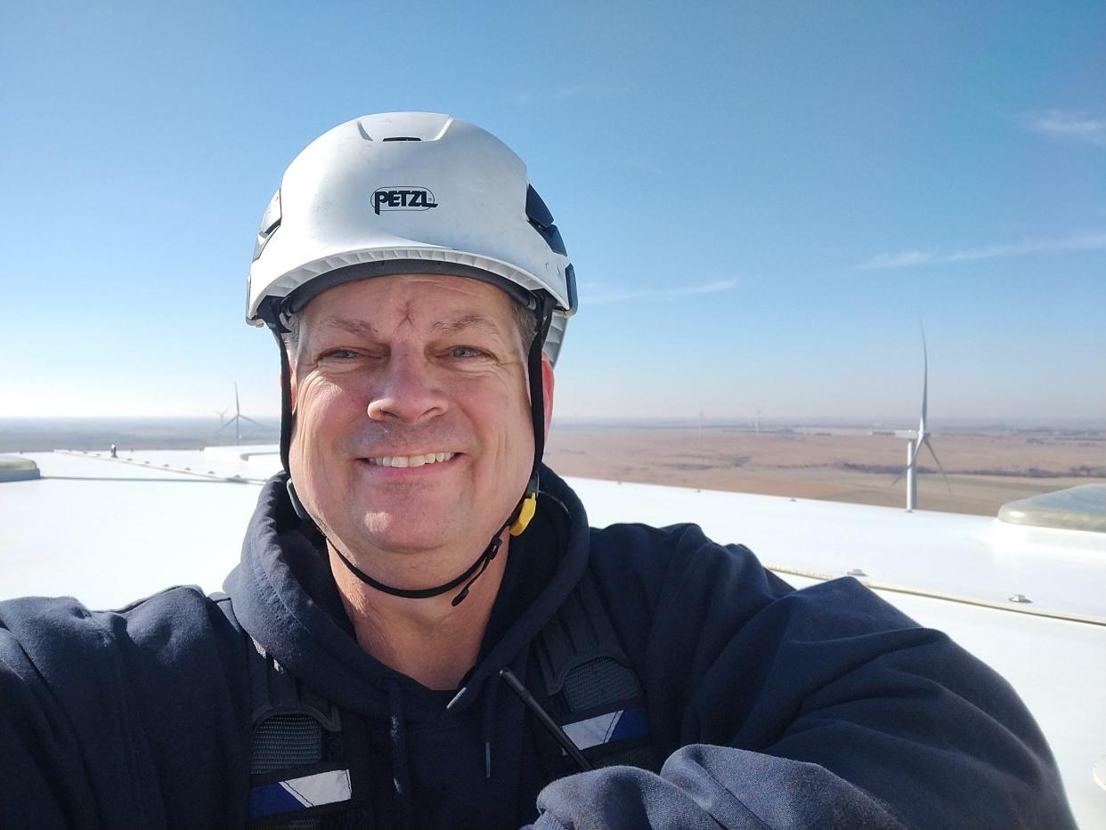 Wind technician Barry Watkins atop a turbine at his work site near Tampa, Kan.