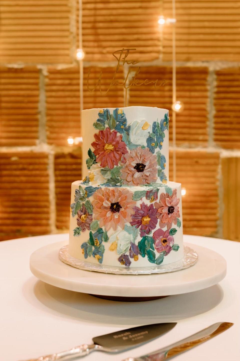 Stella Holmes, Ashlyn Haury's mother and the owner of Stella's Studio Art, paints flowers on wedding cakes made by Ashlyn's Sweet Revenge.