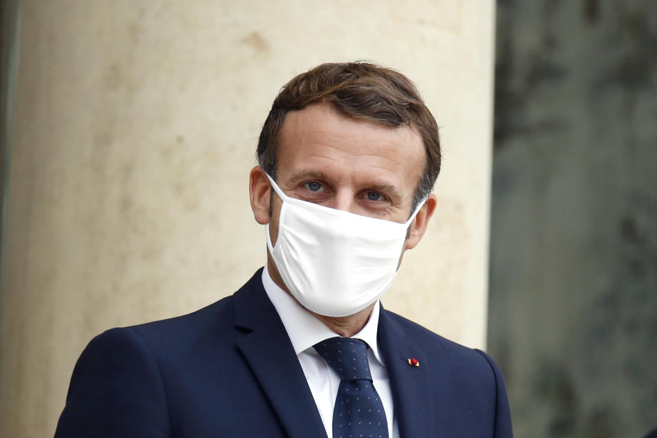 France's President Emmanuel Macron wears a mask as he waits for Estonia's Prime Minister Juri Ratas, prior to a meeting at the Elysee Palace, in Paris, Wednesday, Oct. 28, 2020. France is bracing for a potential new lockdown as the president prepares a televised address Wednesday aimed at stopping a fast-rising tide of virus patients filling French hospitals and a growing daily death toll. French markets opened lower on expectations that President Emmanuel Macron will announce some kind of lockdown Wednesday. (AP Photo/Thibault Camus)