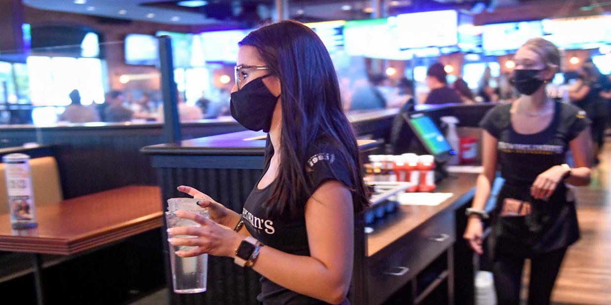 A server carries drinks to a table at P.J. Whelihan's restaurant and pub in Spring Township, Pennsylvania.