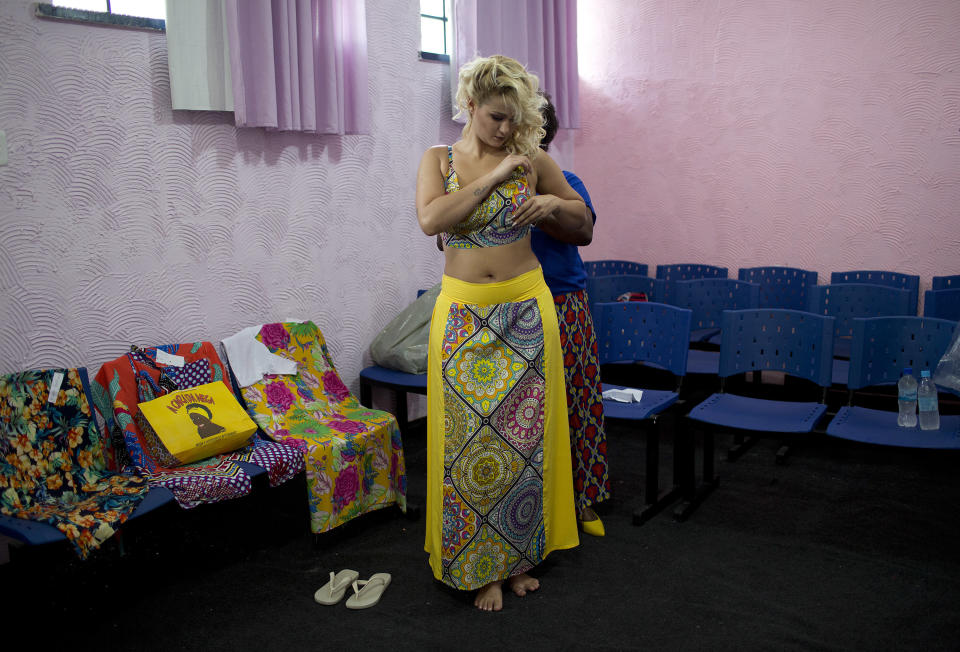 Inmate Mariana Santos da Silva, 23, who is serving time prepares to compete at the annual beauty contest at Talavera Bruce penitentiary in Rio de Janeiro, Brazil, Tuesday, Dec. 4, 2018. The clothes the contestants compete in are on loan from a local business. (AP Photo/Silvia Izquierdo)