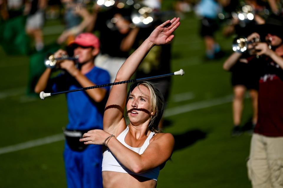 Twirler Grace Wennerberg performs during Michigan State University Marching Band's practice on Wednesday, Aug. 30, 2023, on the MSU campus in East Lansing.