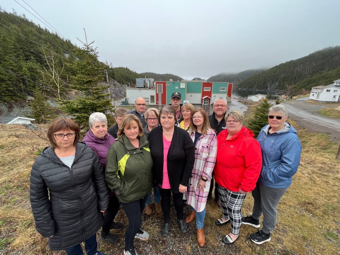 Triton plant workers, including Doretta Strickland, centre, in black coat; Yvonne Short, fourth from right, in pink and white plaid coat; and Rita Lush, second from right, in red coat; are anxiously waiting to get back to work.  (Terry Roberts/CBC - image credit)