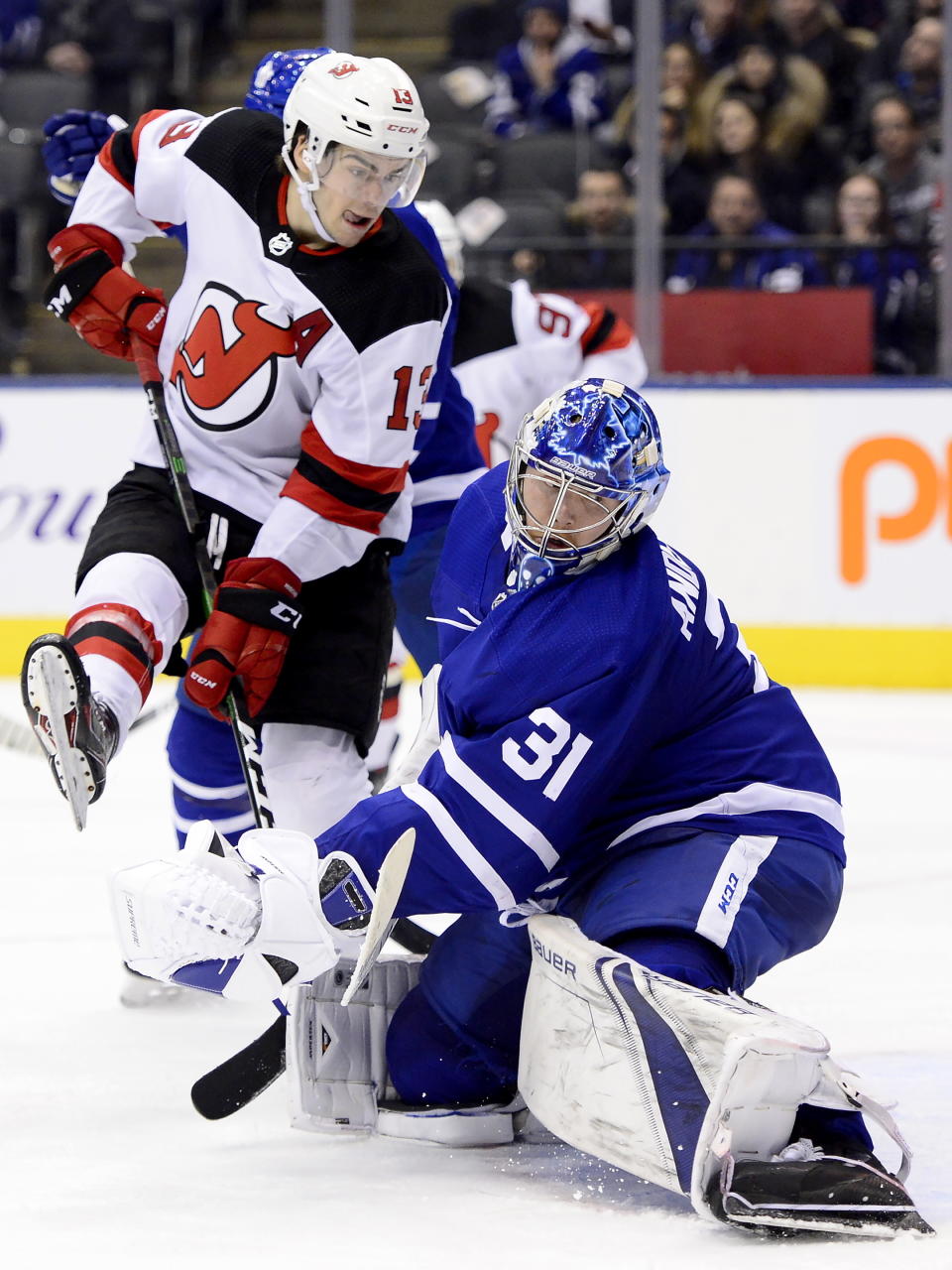 Toronto Maple Leafs goaltender Frederik Andersen (31) looks back as the puck goes in, next to New Jersey Devils center Nico Hischier (13) during the third period of an NHL hockey game Tuesday, Jan. 14, 2020, in Toronto. (Frank Gunn/The Canadian Press via AP)