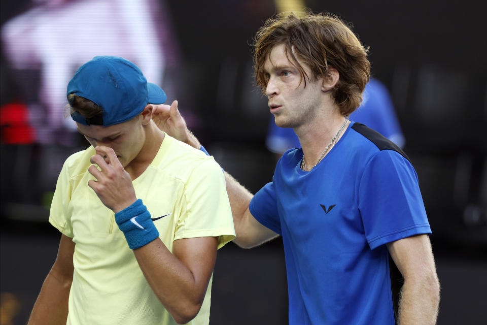 Andrey Rublev, right, of Russia consoles Holger Rune of Denmark following their fourth round match at the Australian Open tennis championship in Melbourne, Australia, Monday, Jan. 23, 2023. (AP Photo/Asanka Brendon Ratnayake)