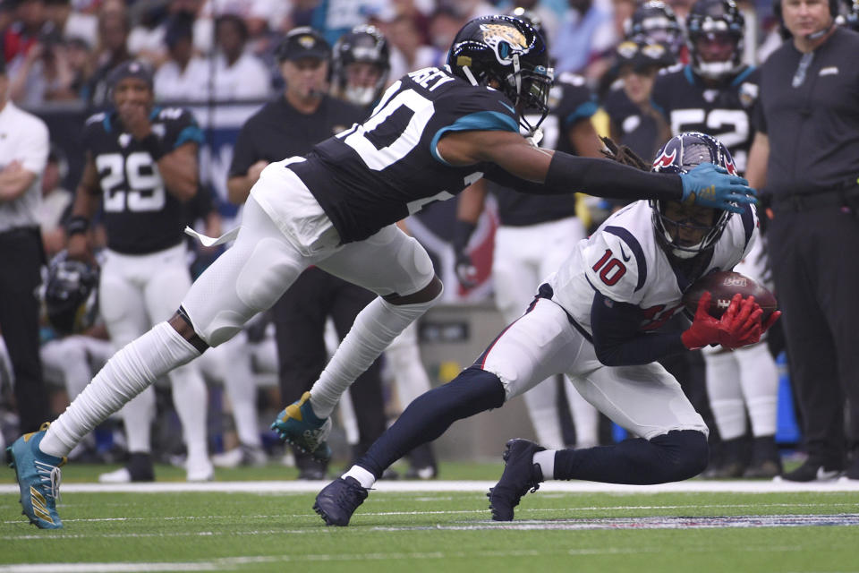 Houston Texans wide receiver DeAndre Hopkins (10) makes a catch in front of Jacksonville Jaguars cornerback Jalen Ramsey (20) during the first half of an NFL football game Sunday, Sept. 15, 2019, in Houston. (AP Photo/Eric Christian Smith)