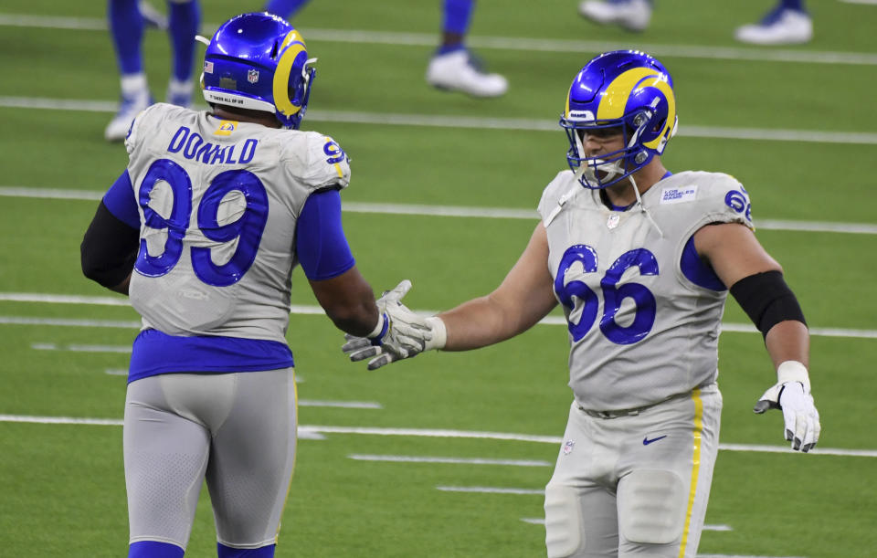 Defensive end Aaron Donald (99) high fives teammate offensive guard Austin Blythe (66) of the Los Angeles Rams after defeating the Dallas Cowboys 20-17 during a NFL football game on opening night at SoFi Stadium in Inglewood on Sunday, September 13, 2020. (Keith Birmingham/The Orange County Register via AP)