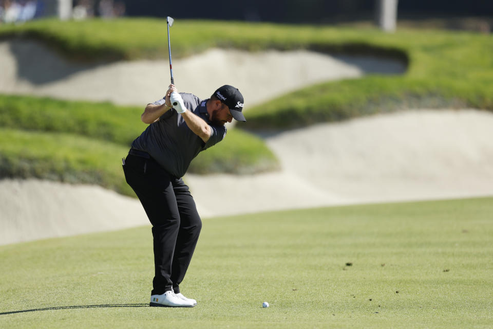 Shane Lowry hits from the fairway on the seventh hole during the final round of the Genesis Invitational golf tournament at Riviera Country Club, Sunday, Feb. 19, 2023, in the Pacific Palisades area of Los Angeles. (AP Photo/Ryan Kang)