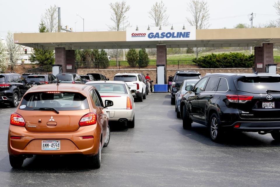 Cars line up for gas outside a Costco Wednesday, May 11, 2022, in Pewaukee, Wis. The Costco offered gas at less than $4 a gallon, some of the cheapest in the area. (AP Photo/Morry Gash)