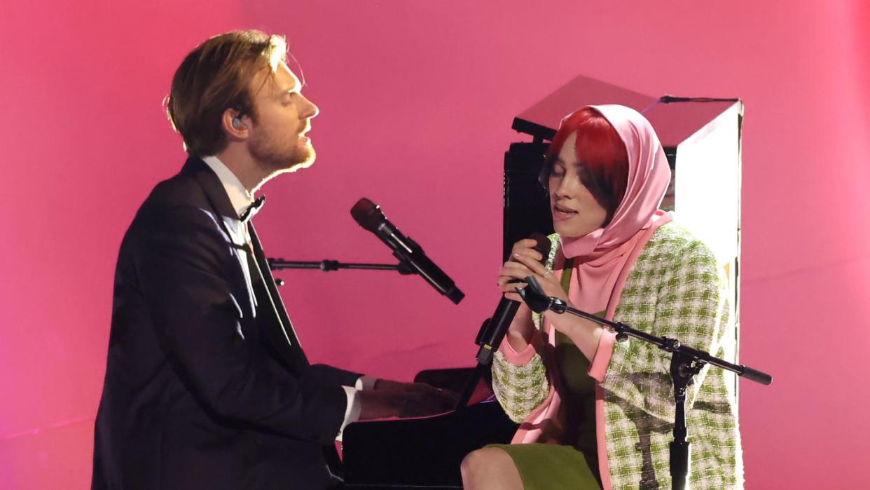 billie eilish with finneas performing at the 66th grammy awards show