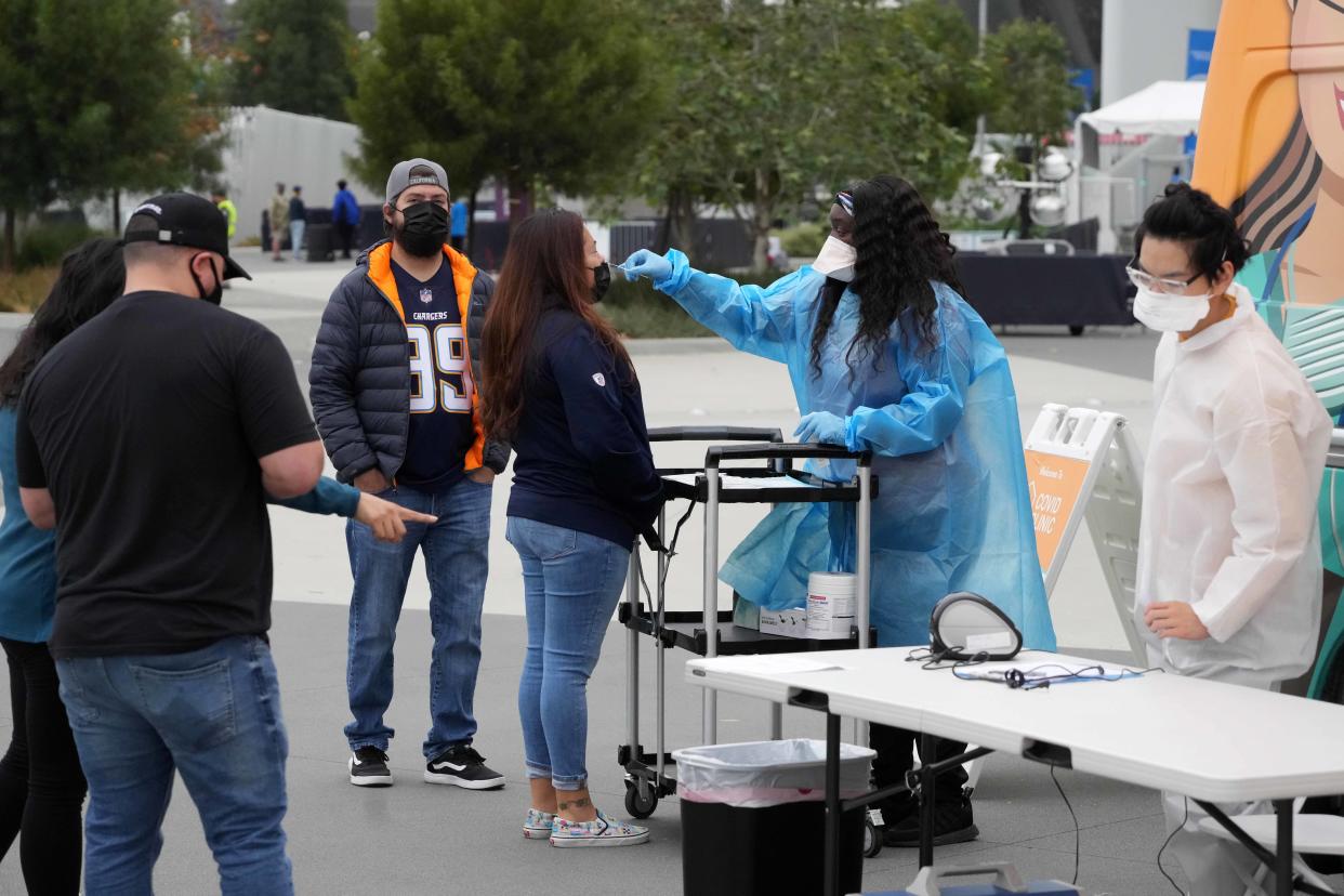 Oct 31, 2021; Inglewood, California, USA; Spectators take a COVID-19 test before the NFL game between the Los Angeles Chargers and the New England Patriots at SoFi Stadium. Mandatory Credit: Kirby Lee-USA TODAY Sports
