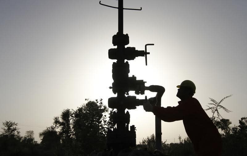 A technician opens a pressure gas valve inside the Oil and Natural Gas Corp (ONGC) group gathering station on the outskirts of Ahmedabad March 2, 2012. REUTERS/Amit Dave/Files