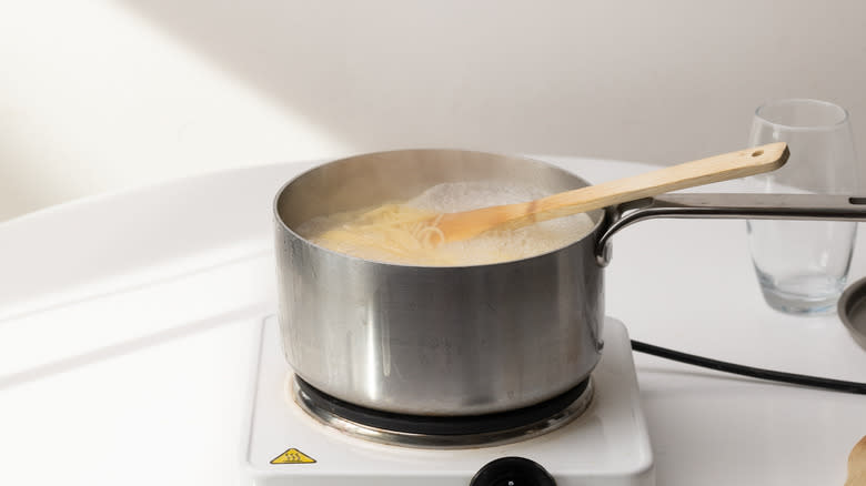 cooking spaghetti in a saucepan