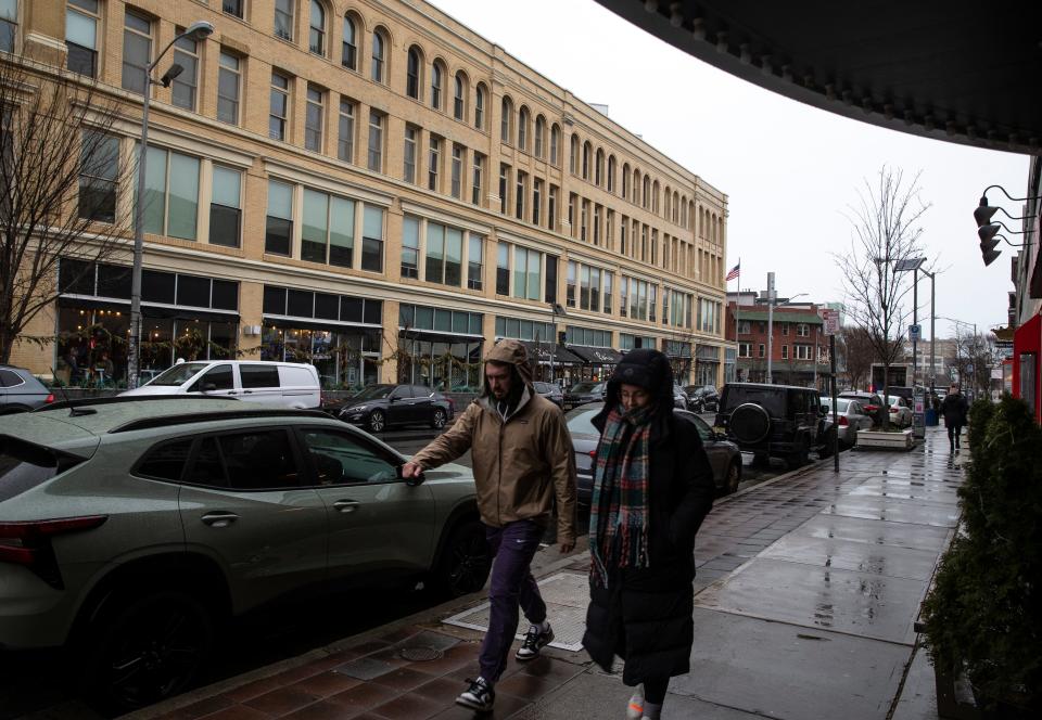 Pedestrians make their way along Cookman Avenue as a potentially severe storm approaches. . Rain begins to fall as a strong storm moves into the Jersey Shore area.  
Asbury Park, NJ
Tuesday, January 9, 2024