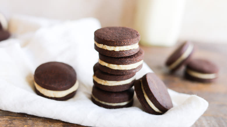 chocolate sandwich cookies stacked on napkin